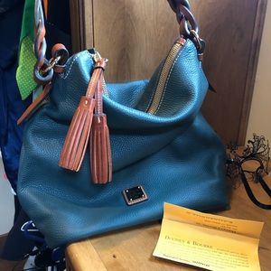 Dooney & Burke pebble grain tassel shoulder bag.